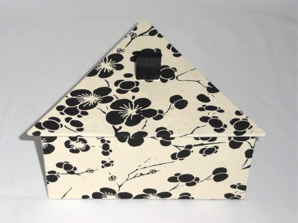 Triangular box with Black Flowers on creme paper.